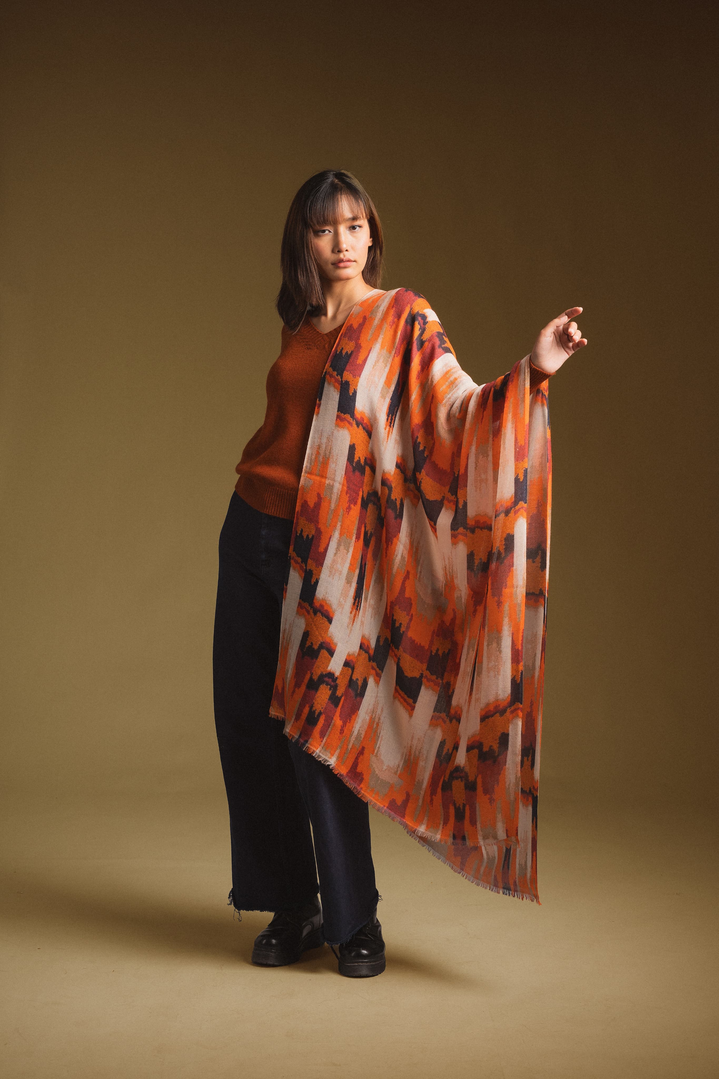 Model draping a hand-painted Himalayan cashmere shawl