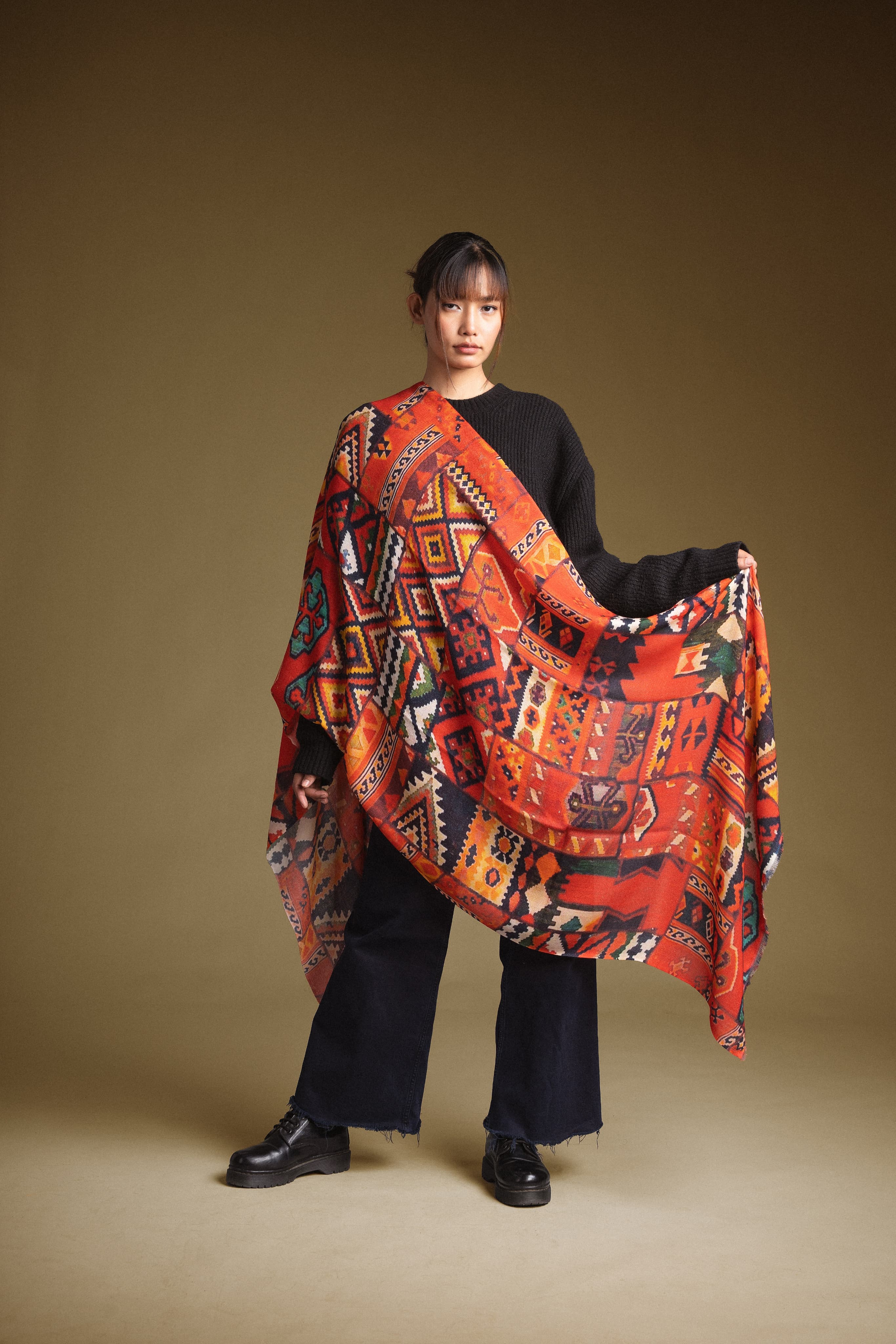 Model holding a hand-painted Himalayan cashmere shawl outdoors