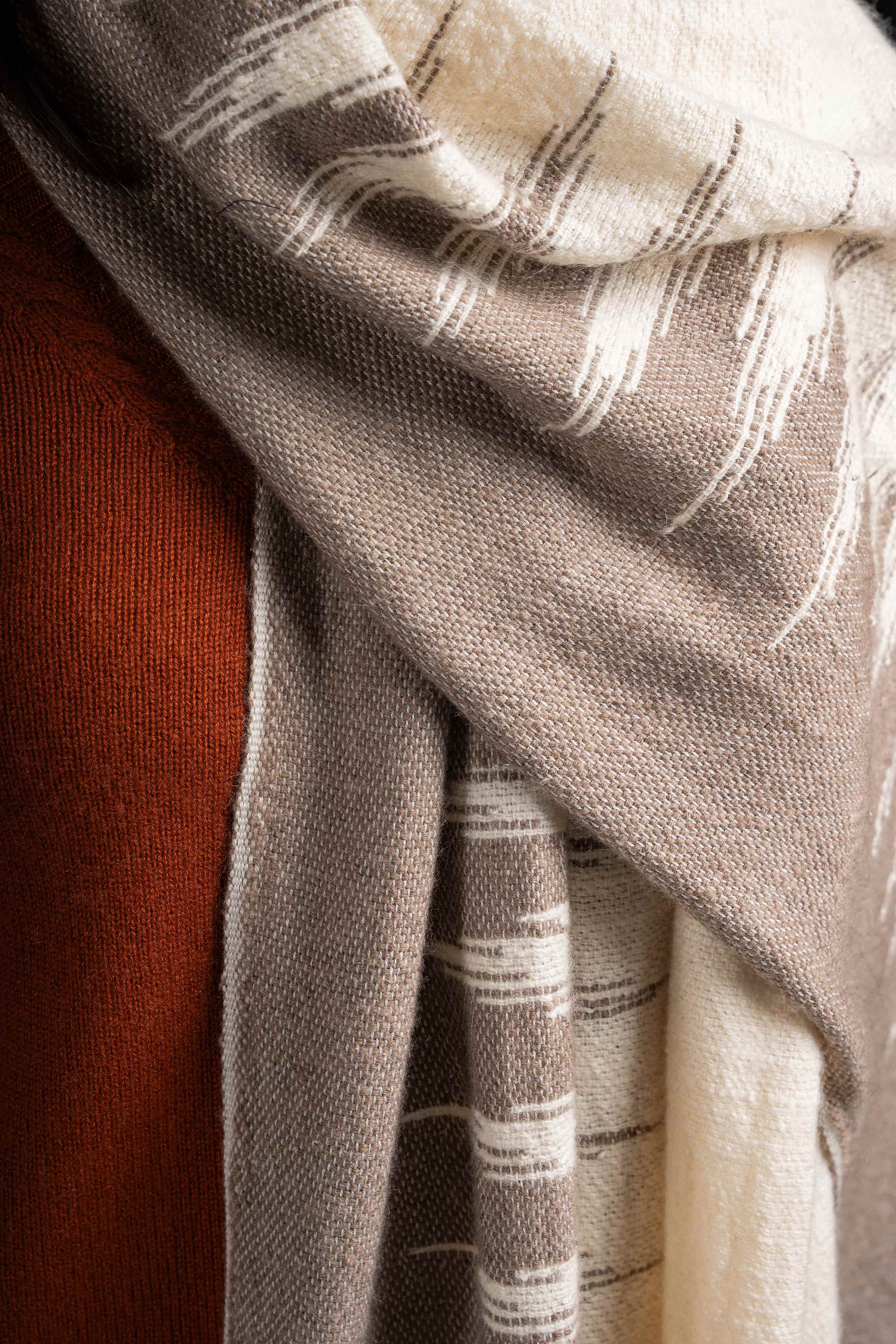 Close-up of folded cashmere garments in earthy tones