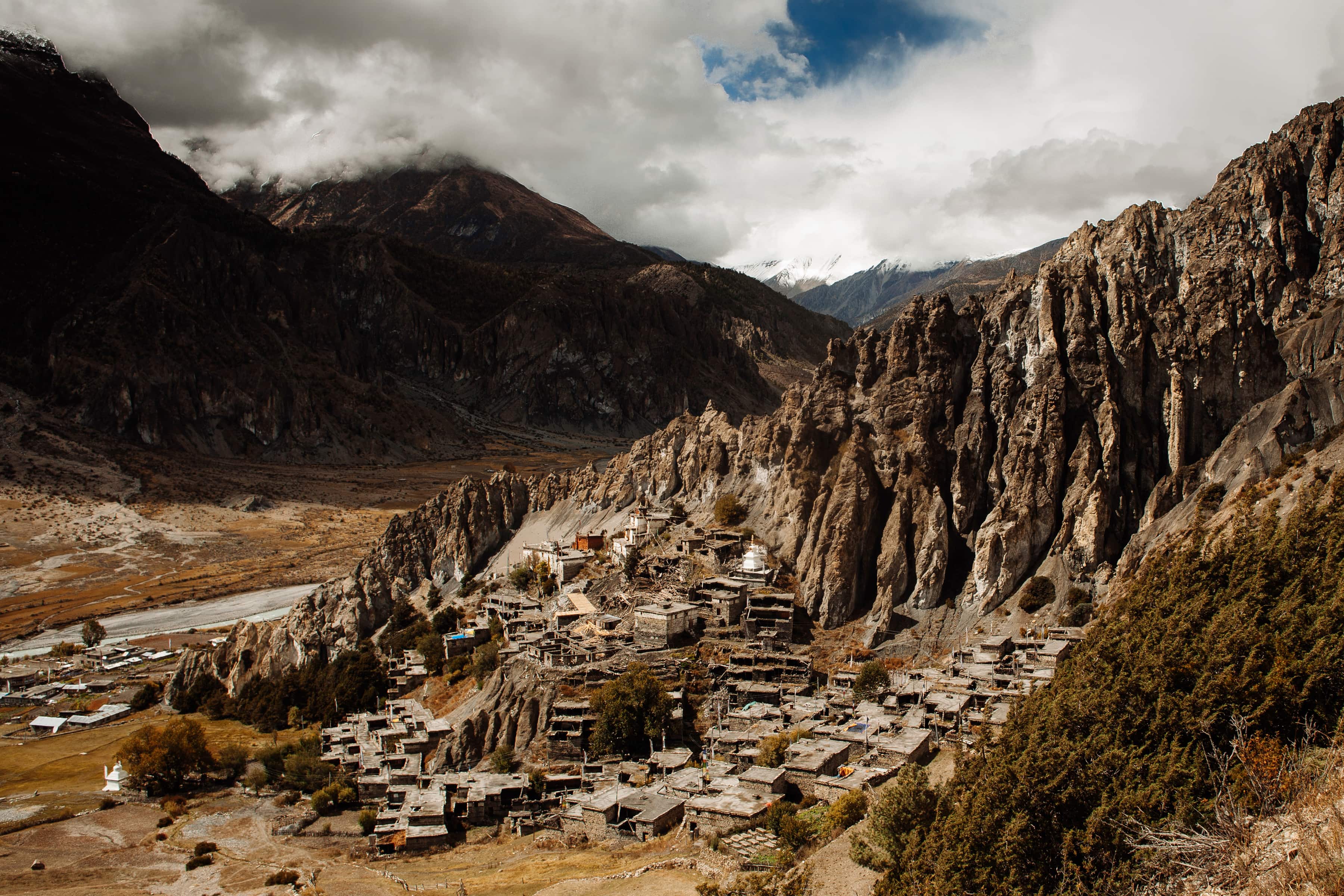 Traditional village nestled among Himalayan mountains and cliffs